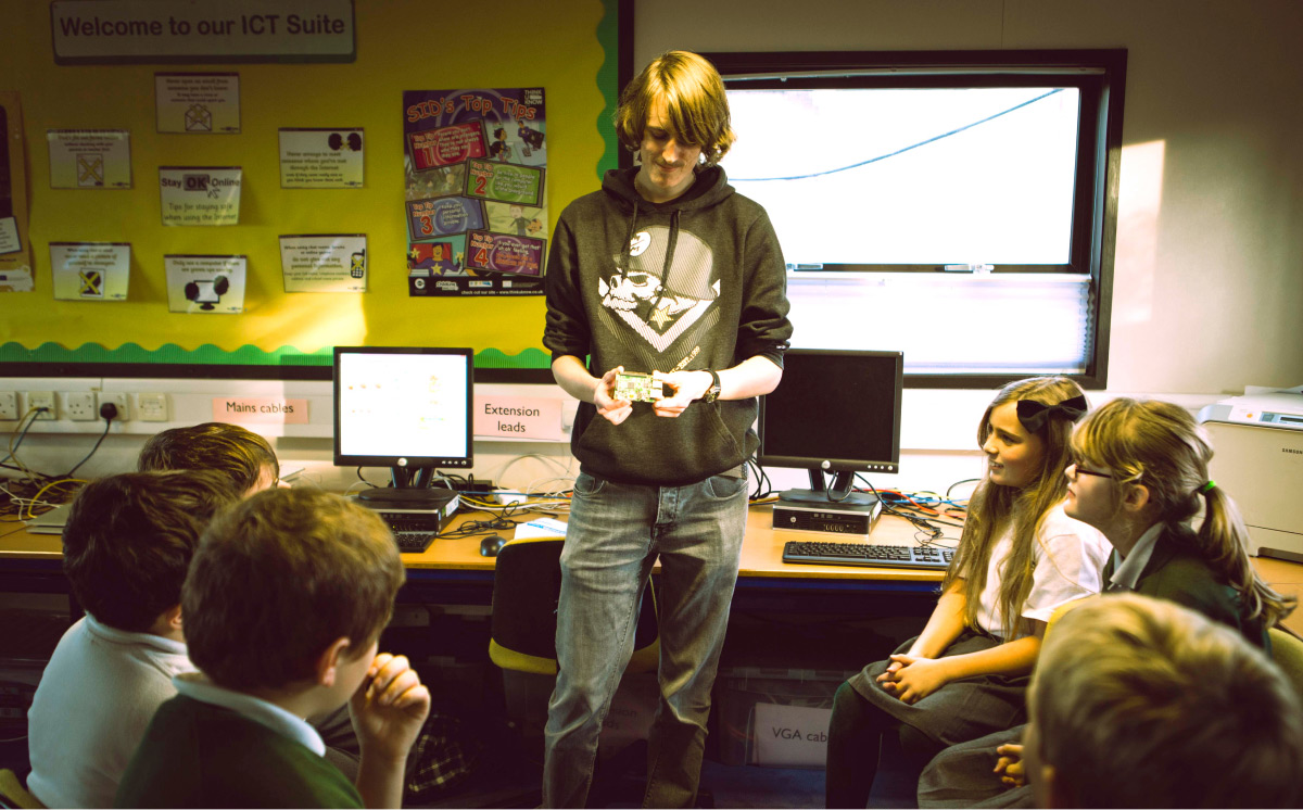 Luke Oliver at Amherst School teaching a group of children at Code Club