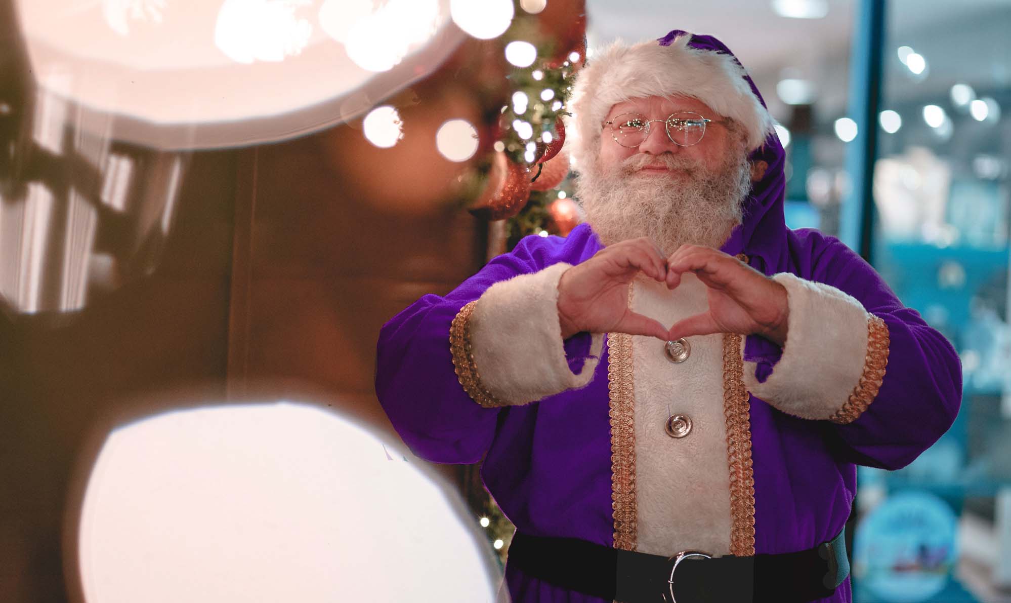 Santa in purple Santa suit