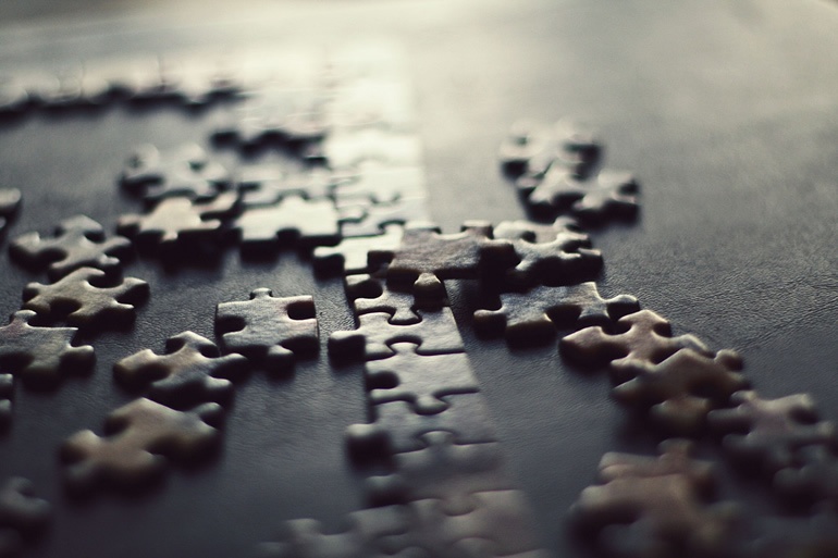 Jigsaw puzzle with scattered pieces