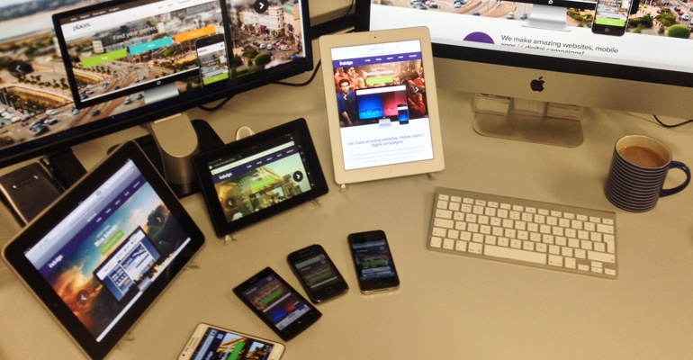 Montage of different devices on a desk used for website testing