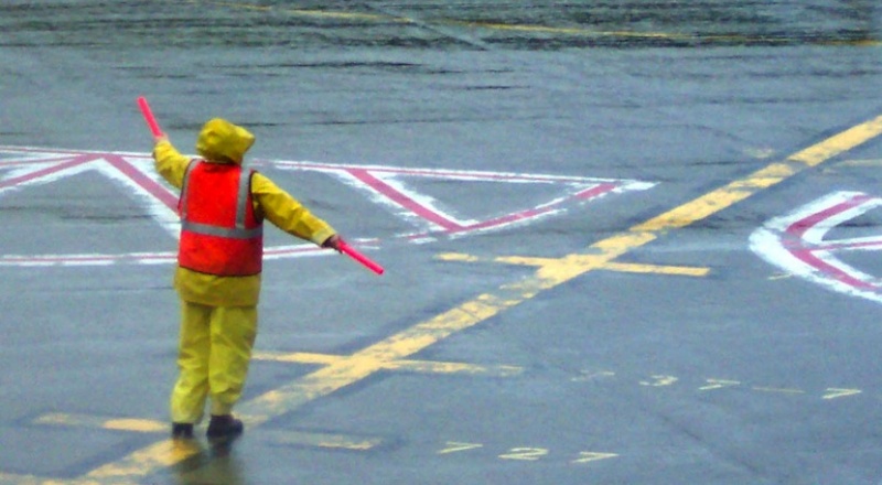 Person aircraft marshalling on a runway