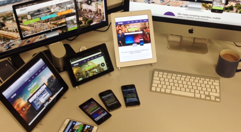 Montage of different devices on a desk used for website testing