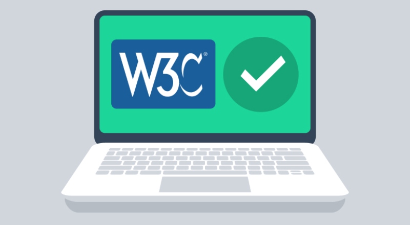 Laptop with W3C logo and a green tick on the screen