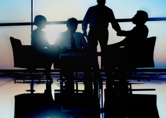 Silhouettes of people in a boardroom